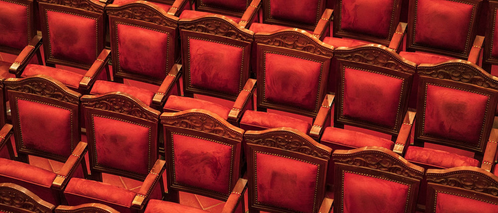 The seats are lined with soft red velvet cushions, creating a feeling of relaxation throughout the performance